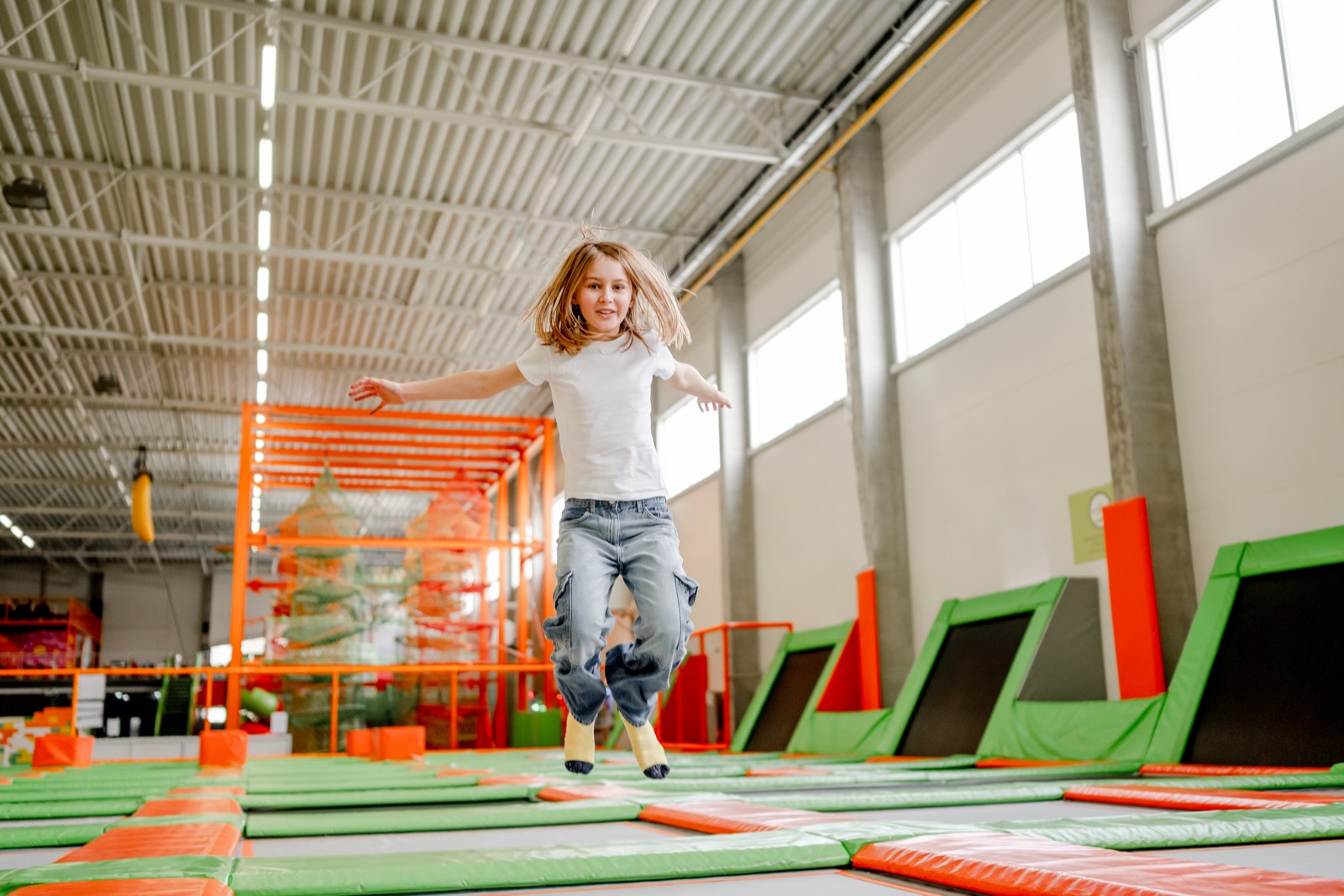 Niña saltando en un parque de trampolines